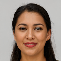 Joyful white young-adult female with long  brown hair and brown eyes