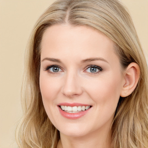 Joyful white young-adult female with long  brown hair and blue eyes