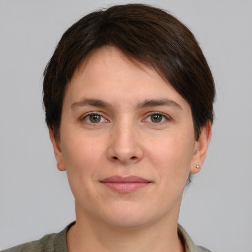 Joyful white young-adult female with short  brown hair and grey eyes