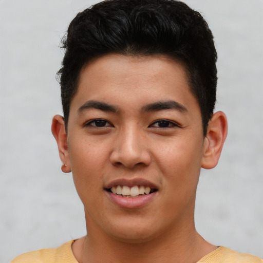 Joyful asian young-adult male with short  brown hair and brown eyes