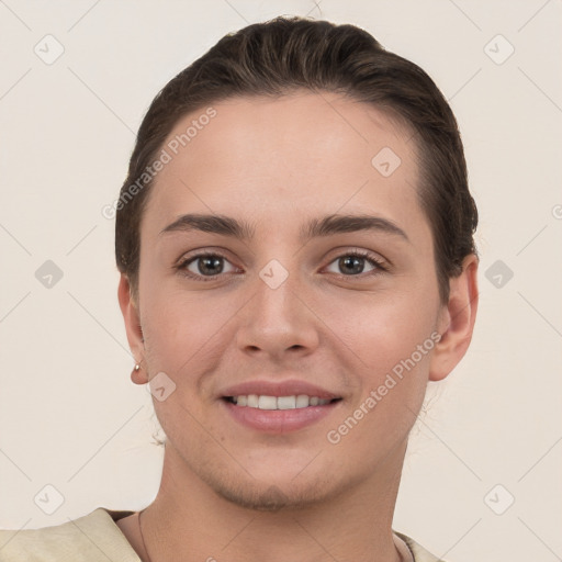 Joyful white young-adult female with short  brown hair and grey eyes