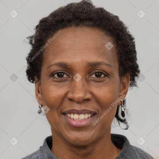 Joyful black adult female with short  brown hair and brown eyes