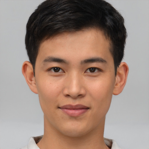 Joyful asian young-adult male with short  brown hair and brown eyes