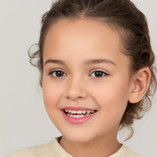 Joyful white child female with medium  brown hair and brown eyes