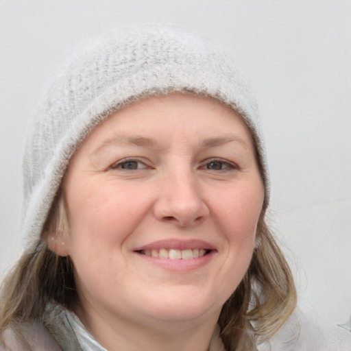 Joyful white young-adult female with medium  brown hair and blue eyes