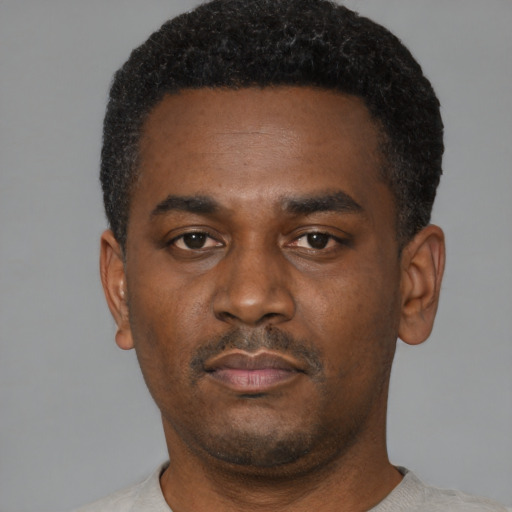 Neutral black young-adult male with short  black hair and brown eyes