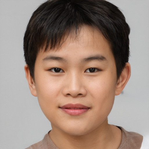 Joyful asian child male with short  brown hair and brown eyes