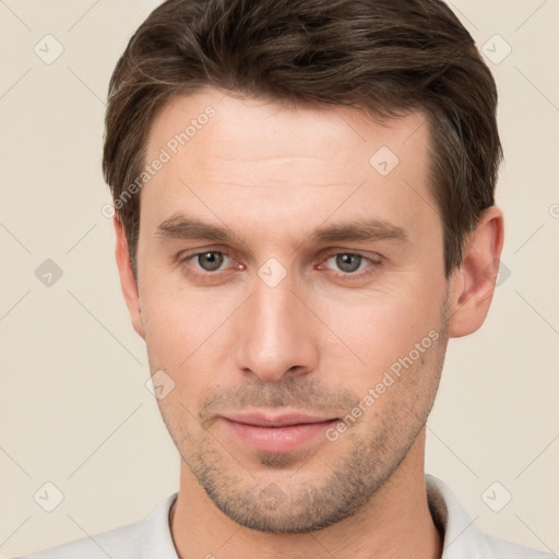 Joyful white young-adult male with short  brown hair and brown eyes