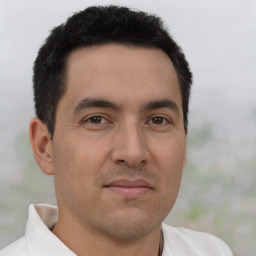 Joyful latino young-adult male with short  brown hair and brown eyes