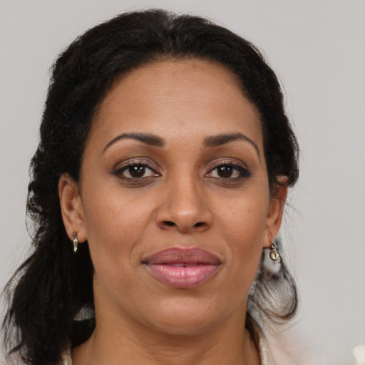 Joyful black adult female with medium  brown hair and brown eyes
