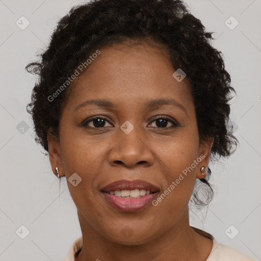 Joyful black adult female with short  brown hair and brown eyes