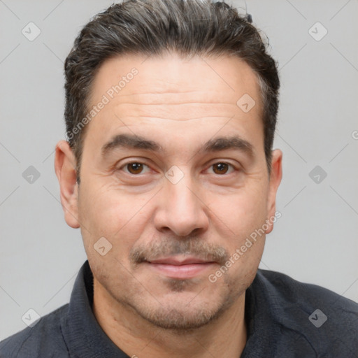 Joyful white adult male with short  brown hair and brown eyes