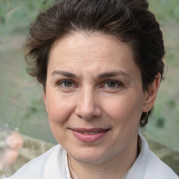 Joyful white adult female with short  brown hair and brown eyes