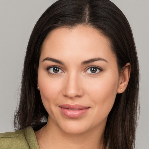 Joyful white young-adult female with long  brown hair and brown eyes