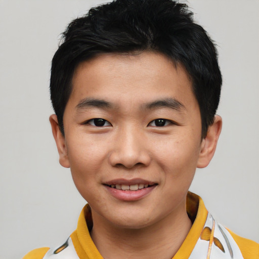 Joyful asian young-adult male with short  black hair and brown eyes