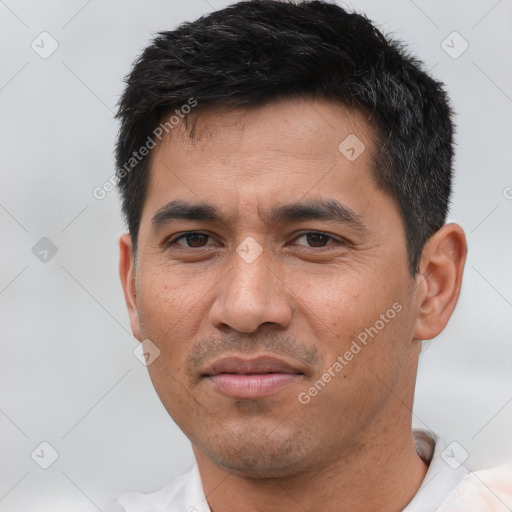 Joyful asian young-adult male with short  black hair and brown eyes