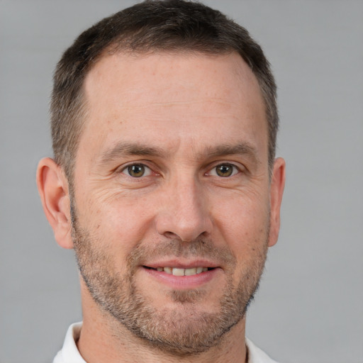 Joyful white adult male with short  brown hair and brown eyes