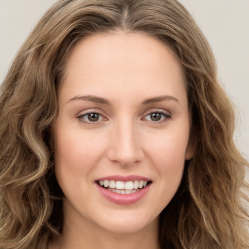 Joyful white young-adult female with long  brown hair and green eyes