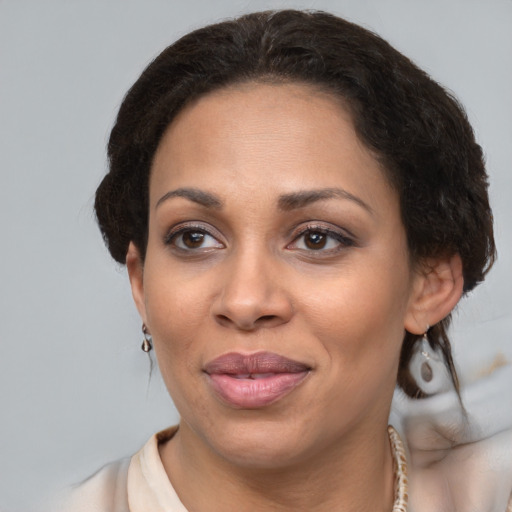 Joyful black adult female with medium  brown hair and brown eyes