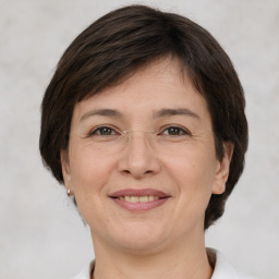 Joyful white adult female with short  brown hair and brown eyes