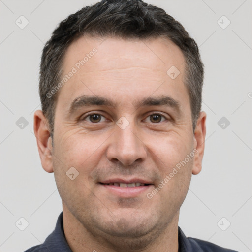 Joyful white adult male with short  brown hair and brown eyes