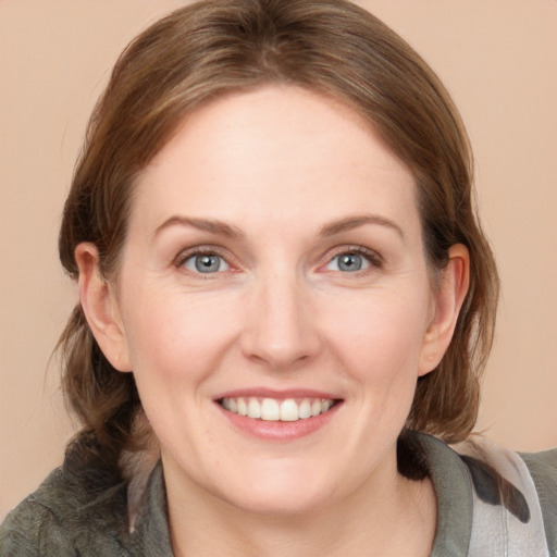 Joyful white young-adult female with medium  brown hair and blue eyes