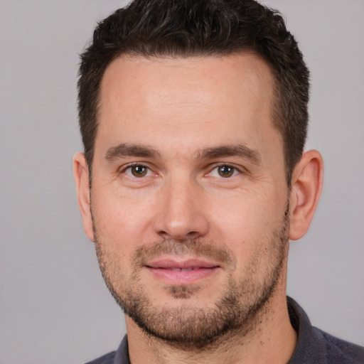 Joyful white young-adult male with short  brown hair and brown eyes