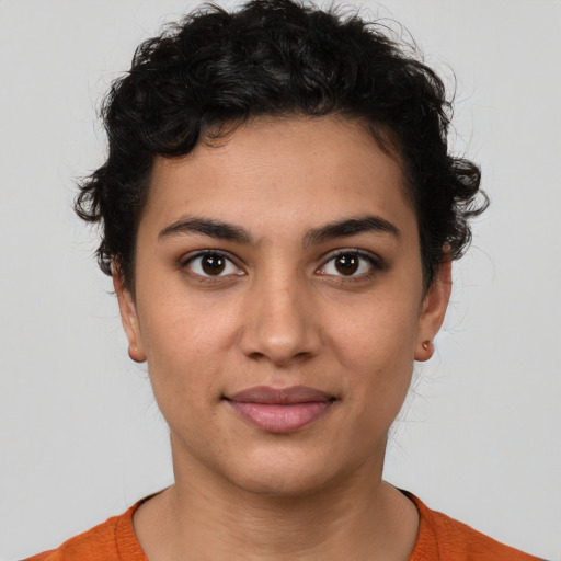 Joyful latino young-adult female with short  brown hair and brown eyes