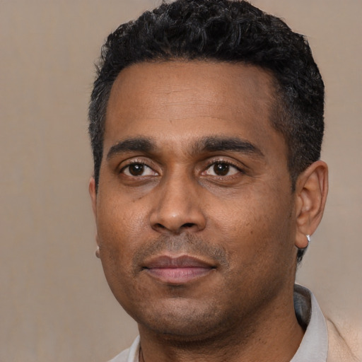 Neutral latino adult male with short  black hair and brown eyes