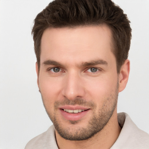 Joyful white young-adult male with short  brown hair and brown eyes