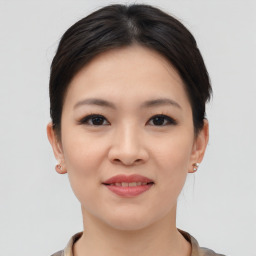 Joyful asian young-adult female with short  brown hair and brown eyes