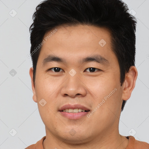 Joyful asian young-adult male with short  brown hair and brown eyes