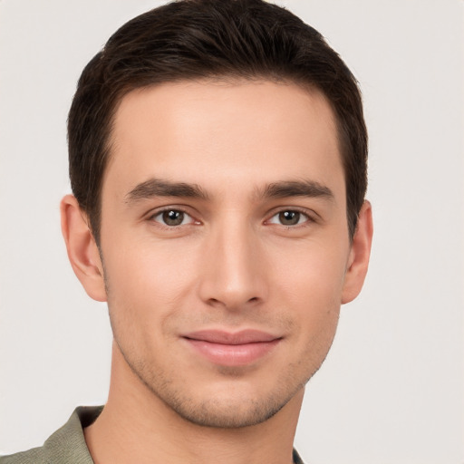 Joyful white young-adult male with short  brown hair and brown eyes