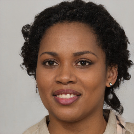 Joyful black young-adult female with long  brown hair and brown eyes