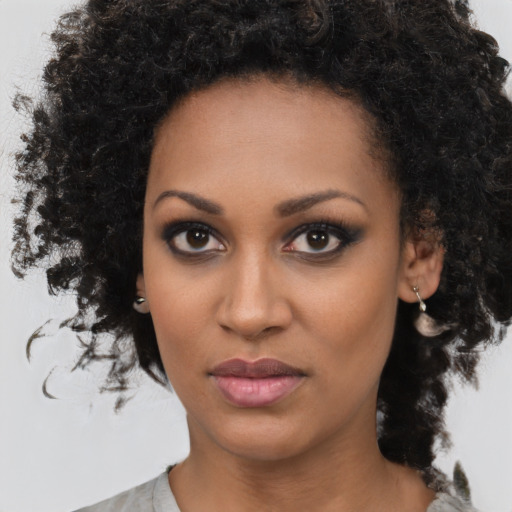 Joyful black young-adult female with medium  brown hair and brown eyes