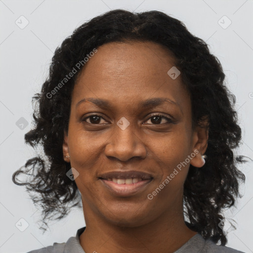 Joyful black adult female with long  brown hair and brown eyes