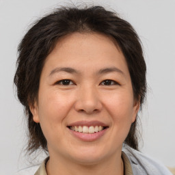 Joyful white adult female with medium  brown hair and brown eyes