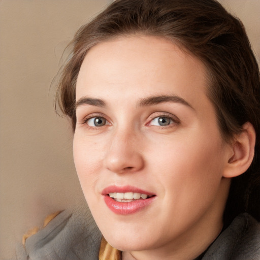 Joyful white young-adult female with long  brown hair and blue eyes