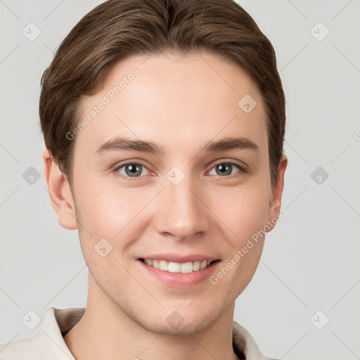 Joyful white young-adult male with short  brown hair and grey eyes