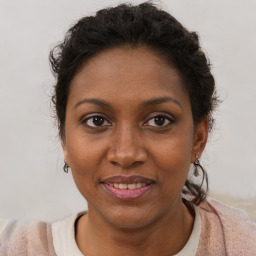 Joyful black adult female with short  brown hair and brown eyes