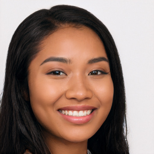 Joyful latino young-adult female with long  black hair and brown eyes