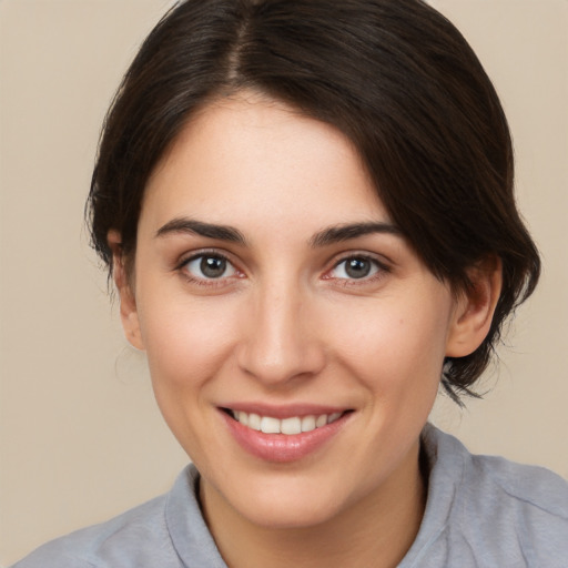 Joyful white young-adult female with medium  brown hair and brown eyes