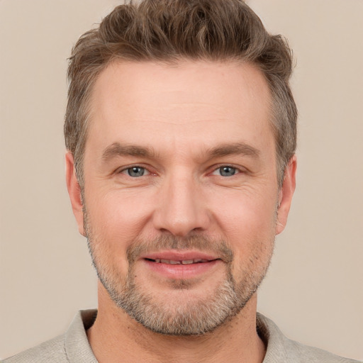 Joyful white adult male with short  brown hair and grey eyes