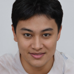 Joyful asian young-adult male with short  brown hair and brown eyes