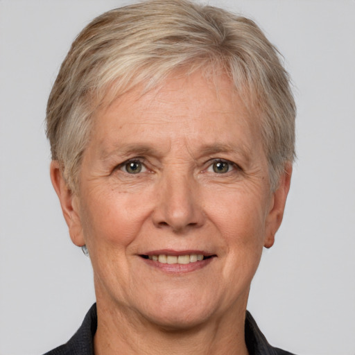 Joyful white middle-aged female with short  gray hair and brown eyes