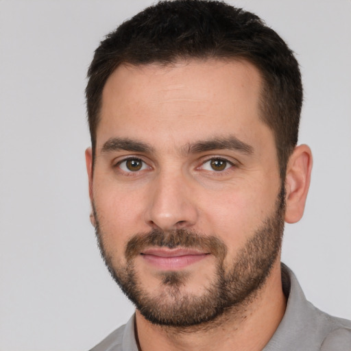 Joyful white young-adult male with short  brown hair and brown eyes