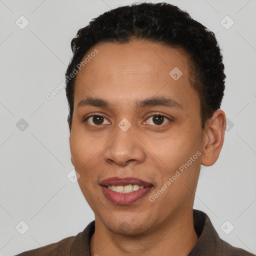 Joyful white young-adult male with short  black hair and brown eyes