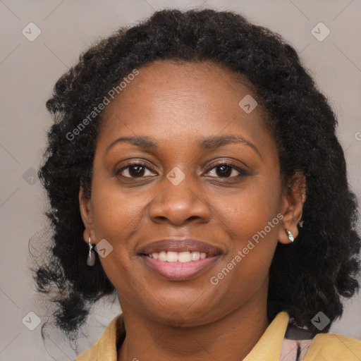 Joyful black adult female with medium  brown hair and brown eyes