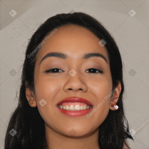 Joyful latino young-adult female with long  black hair and brown eyes