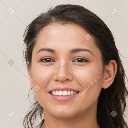 Joyful white young-adult female with long  brown hair and brown eyes